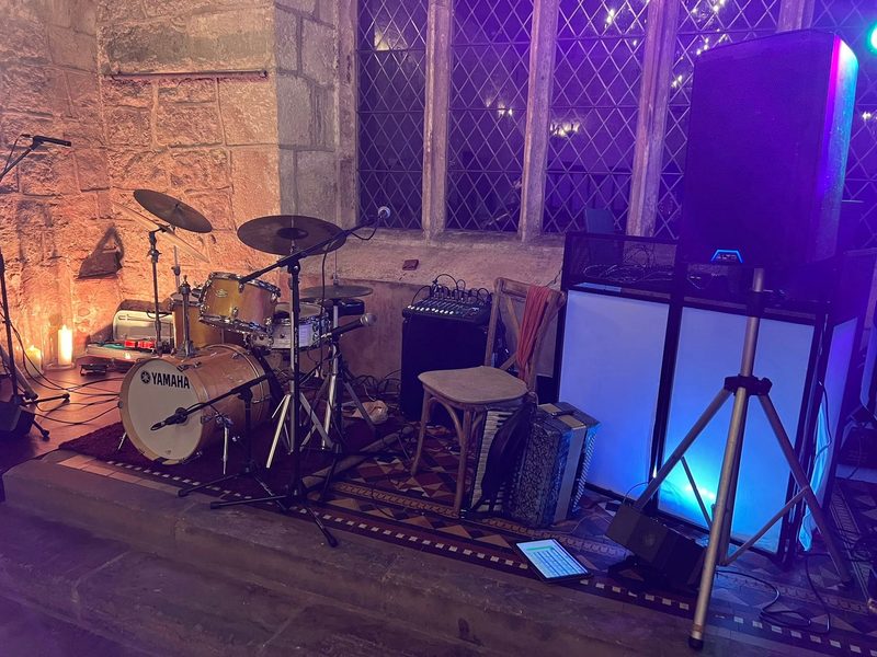 The band's setup in a candlelit castle venue